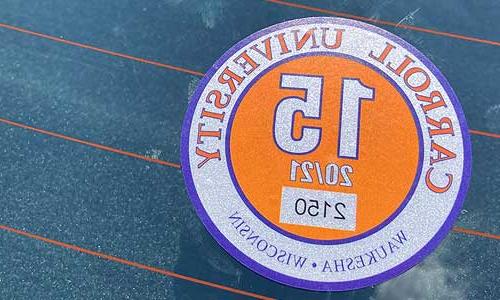 a close up of a Carroll University resident parking permit on a car.